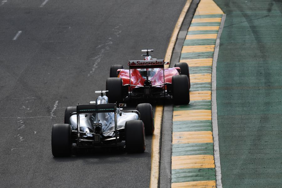 Sebastian Vettel takes a positon from Lewis Hamilton