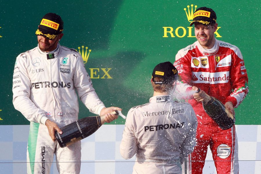 Top 3 drivers celebrate on the podium with the champagne