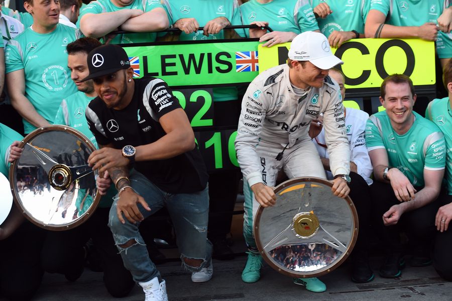 Lewis Hamilton and Nico Rosberg rush away from Merceds' champagne ceremony