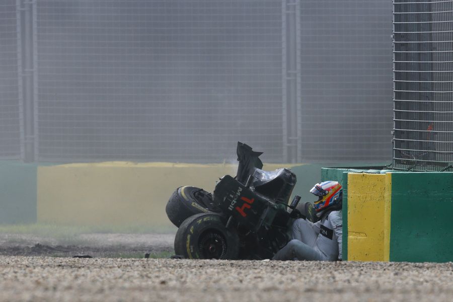 Fernando Alonso leans over on the wall after climbing out of the MP4-31