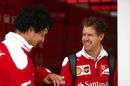 Sebastian Vettel talks with an engineer
