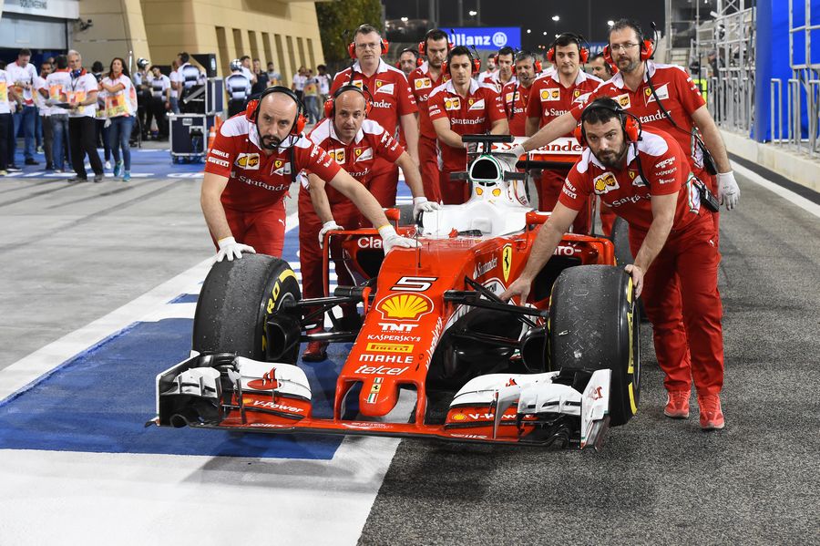Ferrari mechanics push Sebastian Vettel's car to their garage