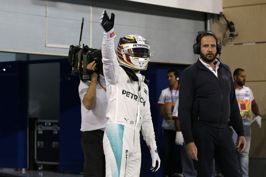 Lewis Hamilton celebrates taking the pole position in parc ferme