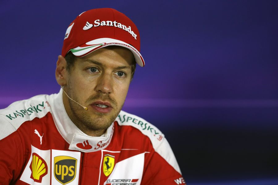 Sebastian Vettel answers a question from media in the press conference