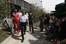 F1 team bosses come out from a meeting in the paddock