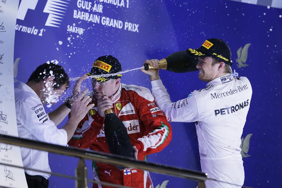 Nico Rosberg celebrates on the podium with Kimi Raikkonen and Aldo Costa