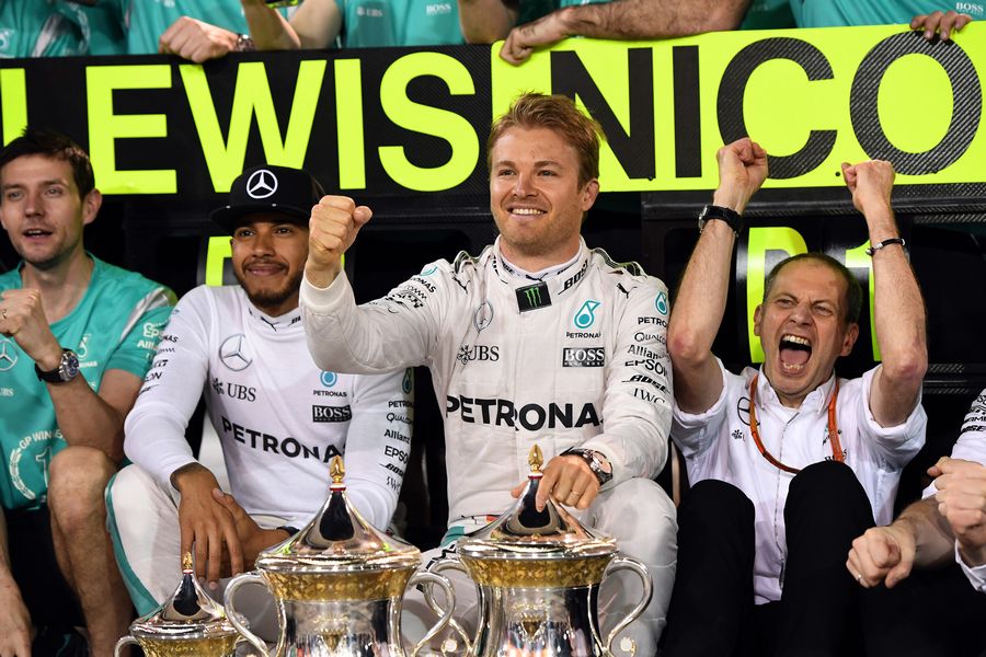 Lewis Hamilton and Nico Rosberg celebrate with the team