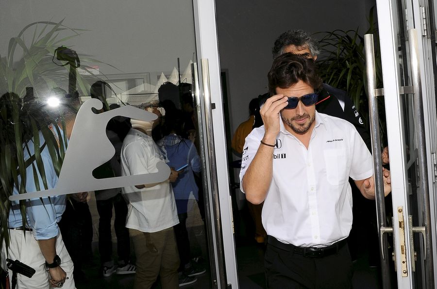 Fernando Alonso leaves the medical centre at Shanghai