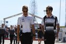 Jenson Button and trainer Mike Collier walk through the paddock