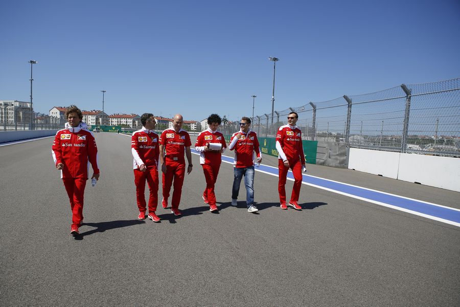 Sebastian Vettel walks the track with his engineers