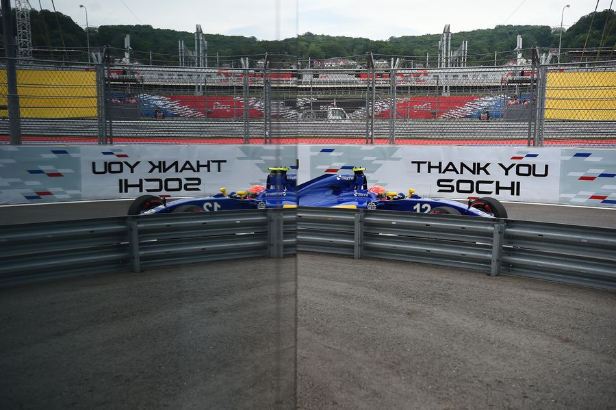 Felipe Nasr reflects against the side of the trackside facility