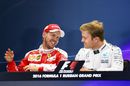 Sebastian Vettel and Nico Rosberg share a joke in the press conference
