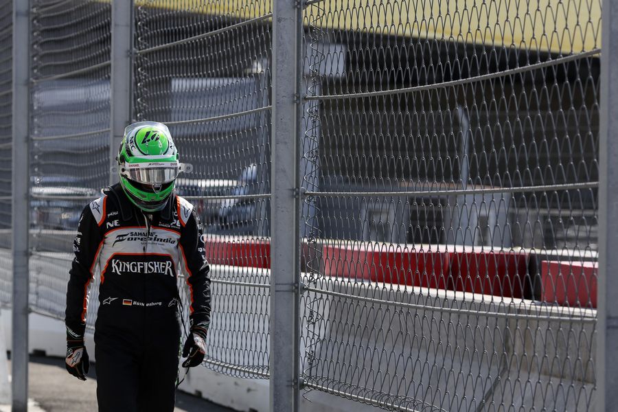 Nico Hulkenberg walks to the pit after his retirement on lap one