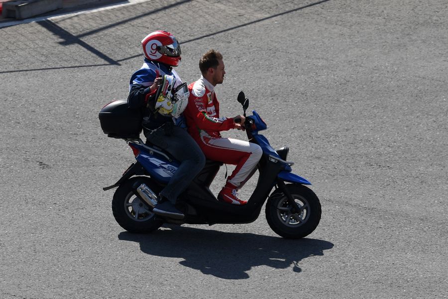 Sebastian Vettel on a moped to returen to the pit after crashed out from the race on lap one