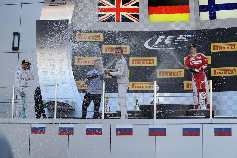 Lewis Hamilton, Nico Rosberg and Kimi Raikkonen celebrate with champagne on the podium