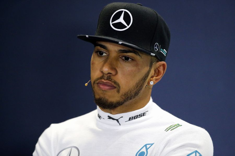 Lewis Hamilton looks on in the press conference