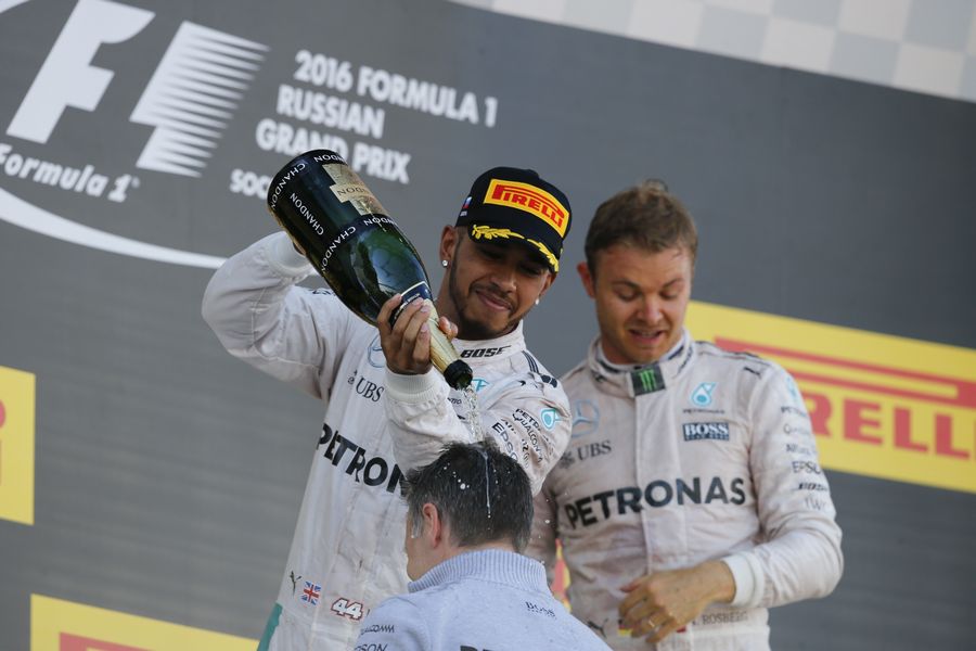 Lewis Hamilton celebrates with the champagne on the podium