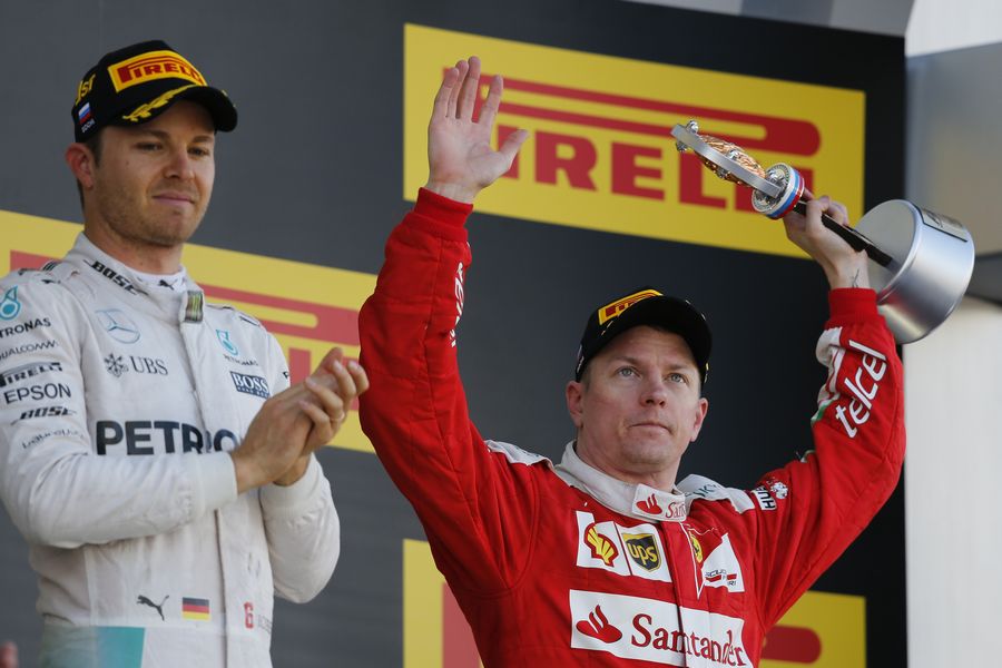 Kimi Raikkonen celebrates with third trophy