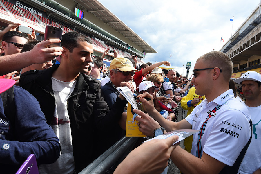 Valtteri Bottas signs autographs for fans