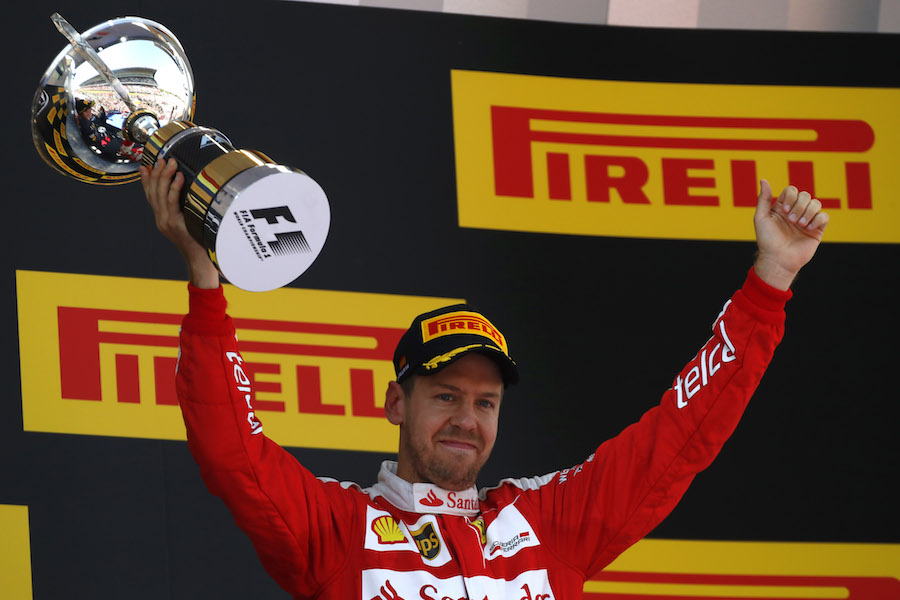 Sebastian Vettel celebrates with the trophy on the podium