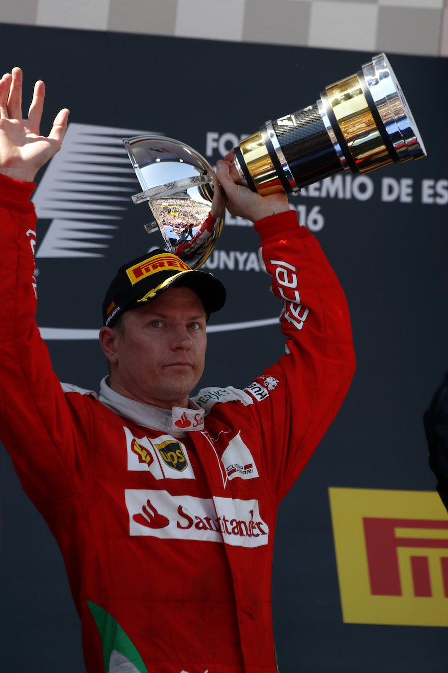Kimi Raikkonen celebrates with the trophy on the podium