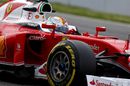 Sebastian Vettel cranks on the steering lock in the Ferrari