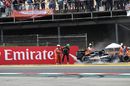 Nico Hulkenberg battles the fires after grabbing the fire extinguisher off the marshal