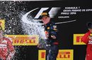 Max Verstappen celebrates on the podium with the champagne