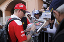 Kimi Raikkonen signs an autograph for fans