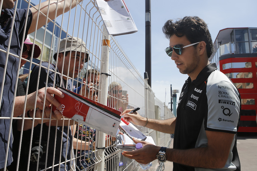 Sergio Perez signs an autograph for fans