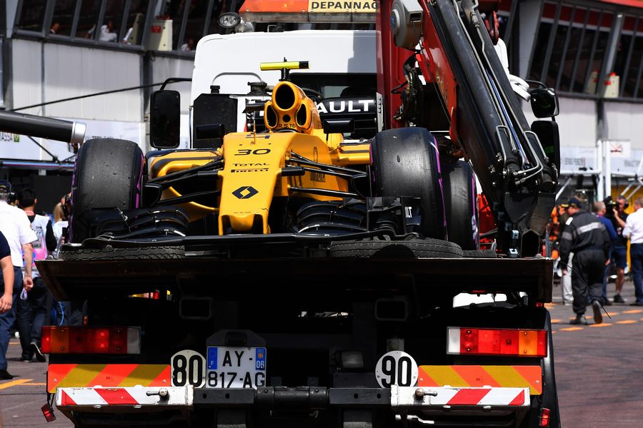 Jolyon Palmer's Renault is recovered to the pits after the accident in FP1
