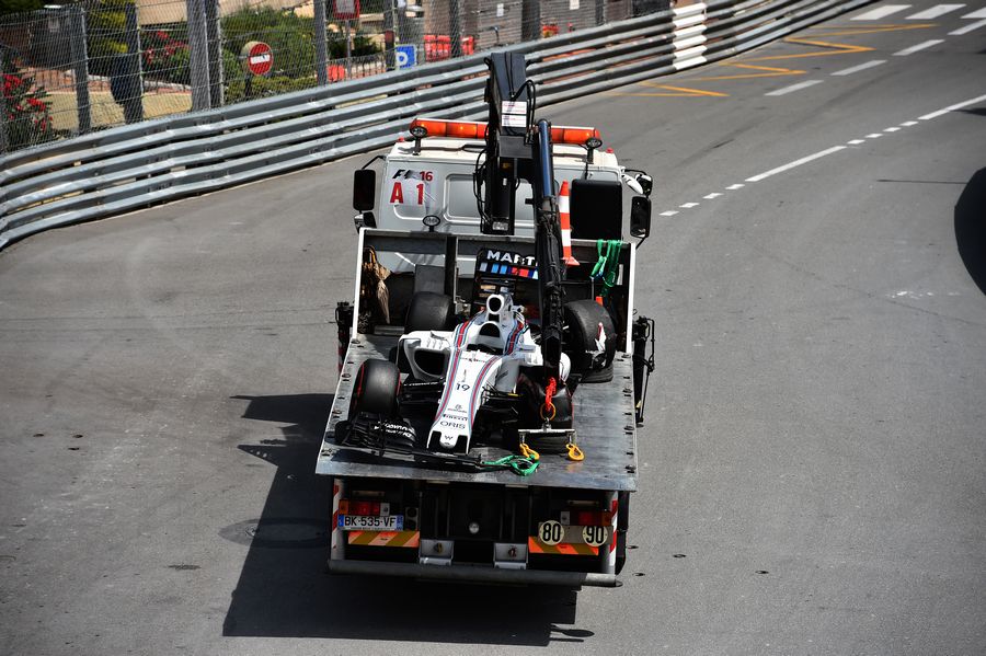 Felipe Massa's Williams FW38 is recovered after crashing in FP1
