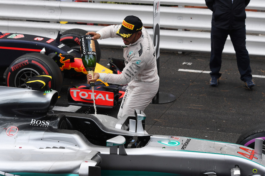 Lewis Hamilton pours champagne on his car
