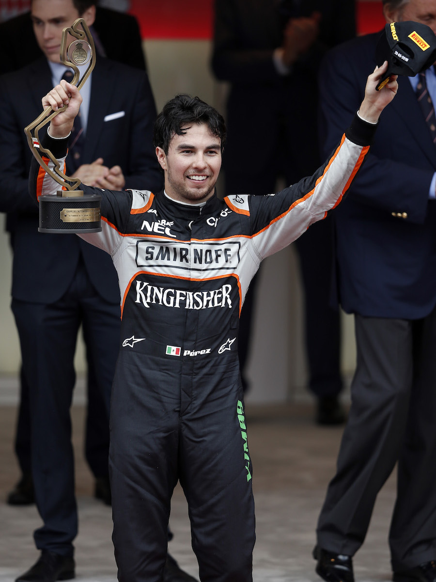 Sergio Perez celebrates on the podium with the trophy