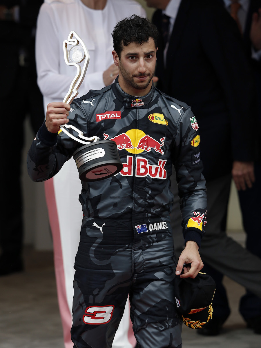 Daniel Ricciardo celebrates on his podium with the trophy