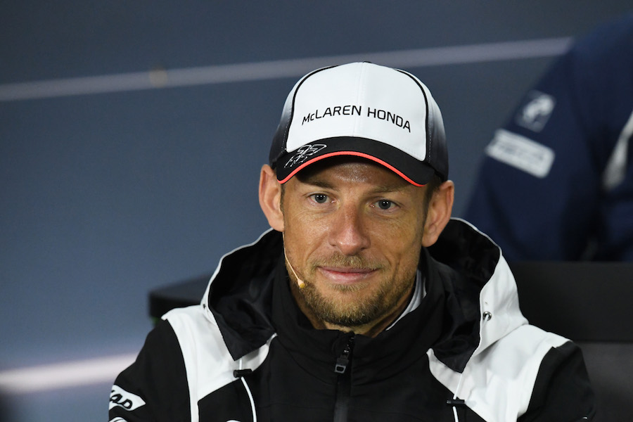 Jenson Button answers a question from media in the press conference