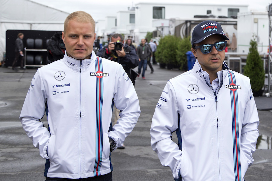 Felipe Massa and Valtteri Bottas walk through the paddock