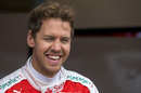 Sebastian Vettel smiles at the garage