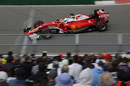 Sebastian Vettel speeds past fans