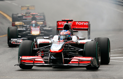 Jenson Button's race ends on the second lap as smoke pours from his McLaren