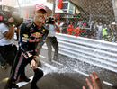 Mark Webber soaks his team with champagne