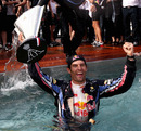 Mark Webber celebrates his win with a dip in the team pool