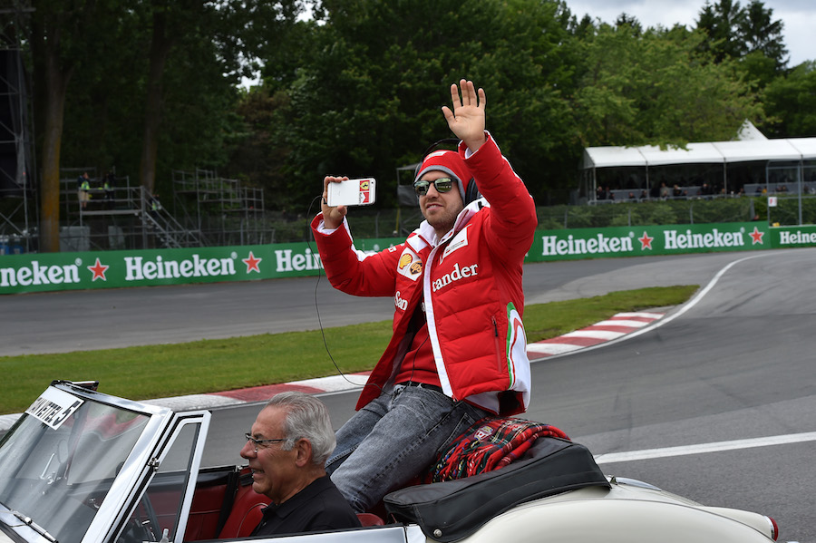 Sebastian Vettel takes a video during the drivers parade
