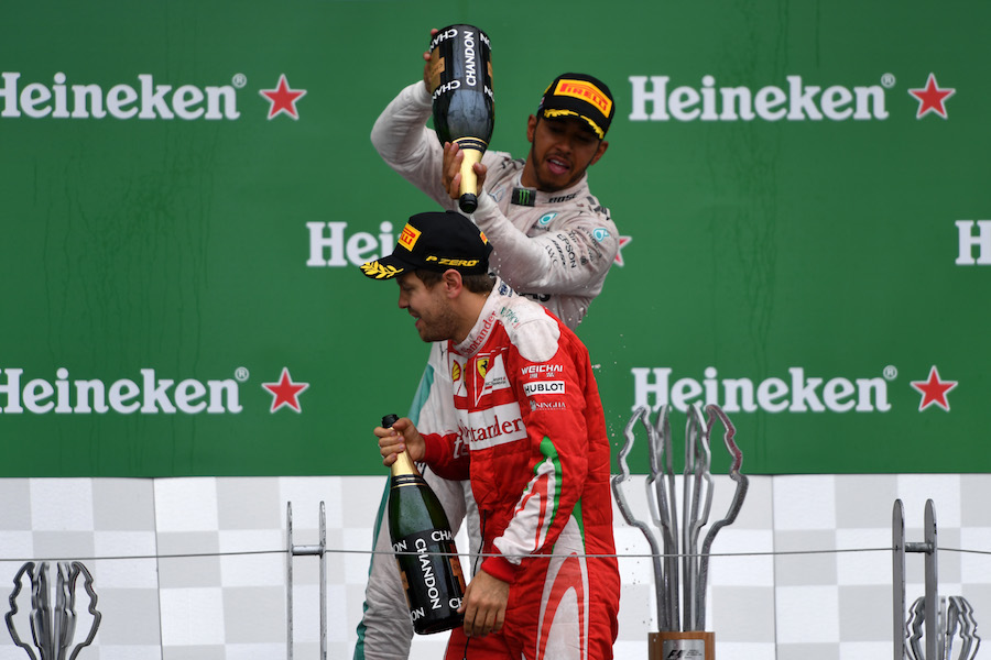 Lewis Hamilton pours champagne on Sebastian Vettel