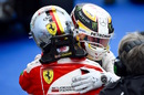 Lewis Hamilton and Sebastian Vettel hug after the race
