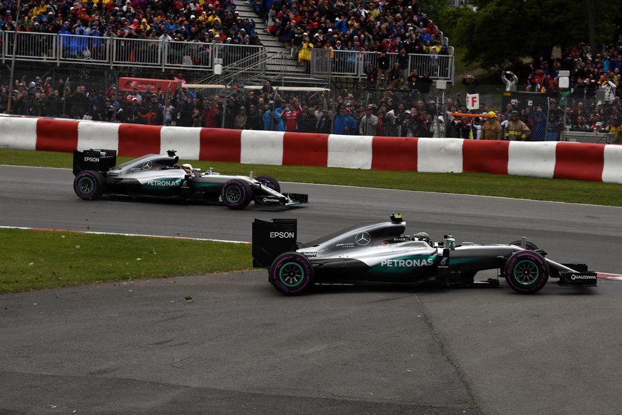 Nico Rosberg runs wide off the track after tapping wheels with teammate Lewis Hamilton