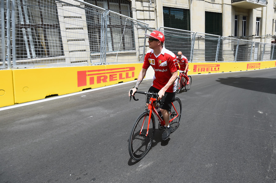 Kimi Raikkonen rides the circuit on a bike