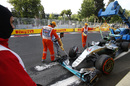 The car of Lewis Hamilton is recovered by the marshals after crashing in Q3 