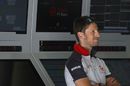 Romain Grosjean looks on at Haas garage