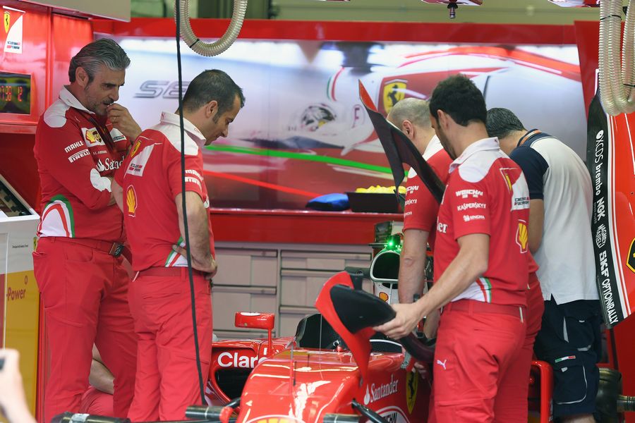 Ferrari mechanics prepare SF16-H with halo device